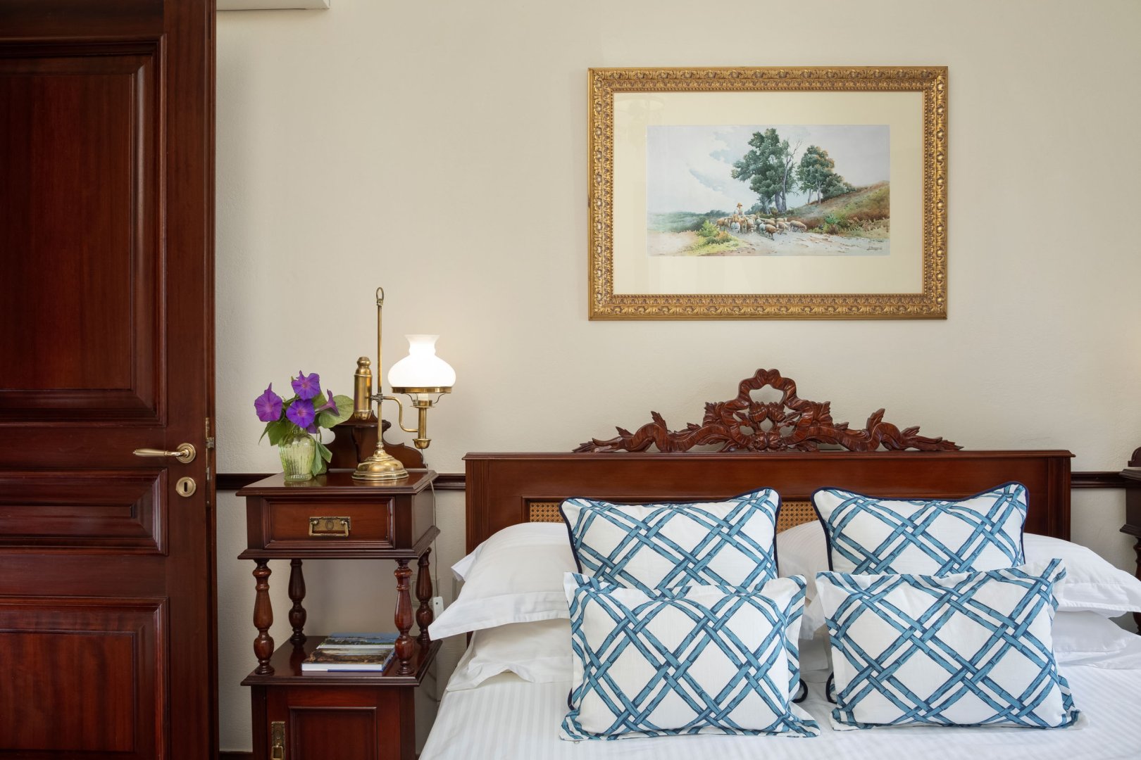 Bedroom with carved wooden headboard